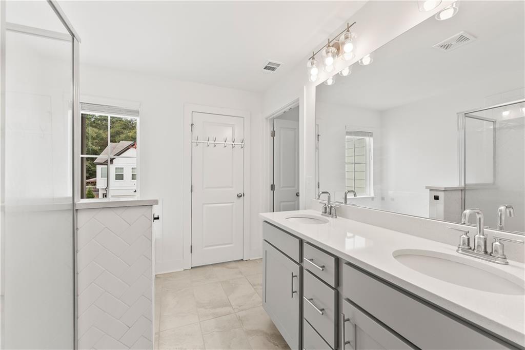 98 Auburn Valley Way Auburn, GA 30011 - Photo 26 of 47 a bathroom with a sink double vanity and a mirror