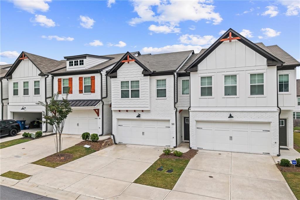 98 Auburn Valley Way Auburn, GA 30011 - Photo 3 of 47 a front view of a house with a garage