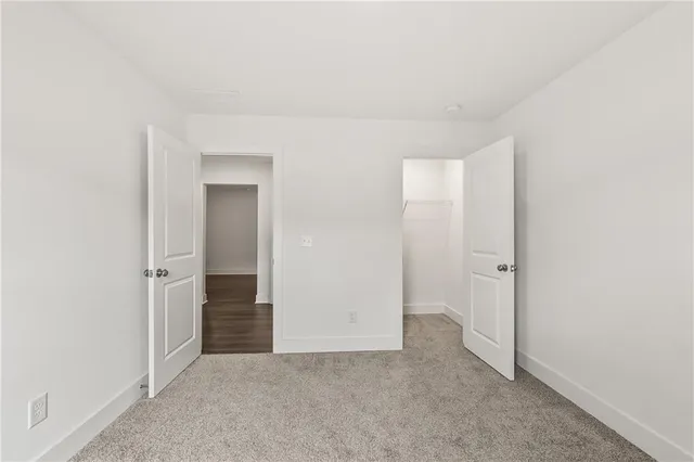 an empty room with a empty space and windows