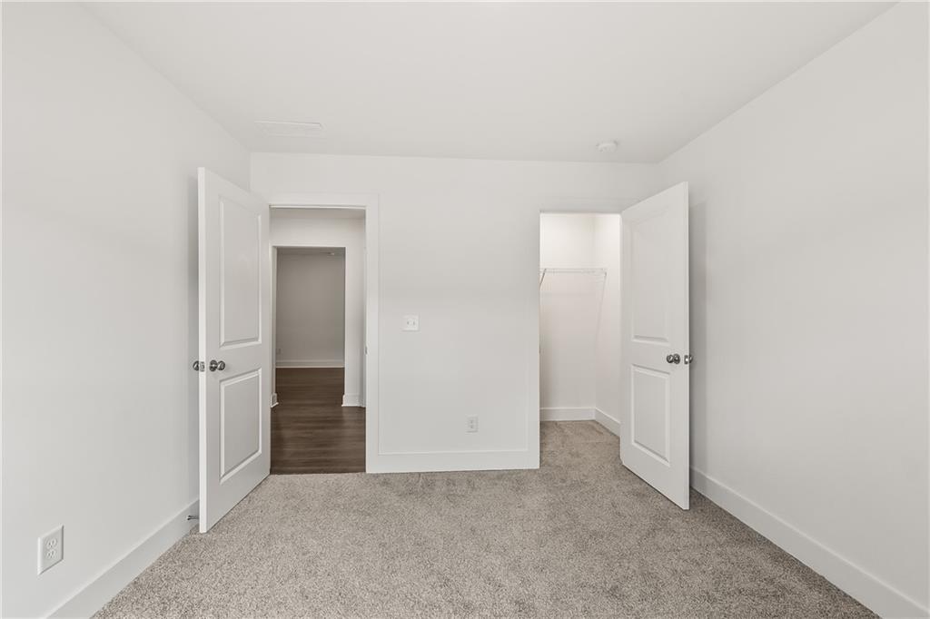 98 Auburn Valley Way Auburn, GA 30011 - Photo 32 of 47 an empty room with closet and a hallway