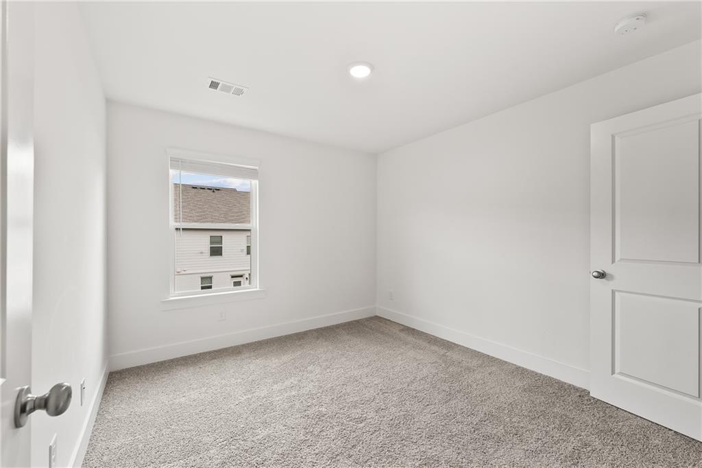 98 Auburn Valley Way Auburn, GA 30011 - Photo 33 of 47 an empty room with a empty space and windows
