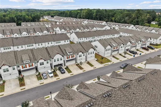 an aerial view of a house with garden space and street view