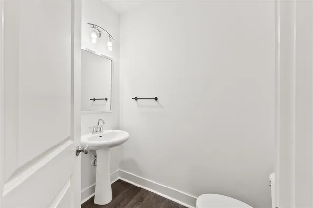 a bathroom with a sink a mirror and toilet