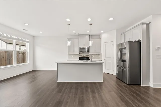 a kitchen with a refrigerator and a sink