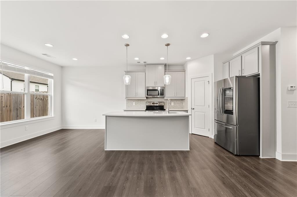 98 Auburn Valley Way Auburn, GA 30011 - Photo 10 of 47 a kitchen with a refrigerator and a sink