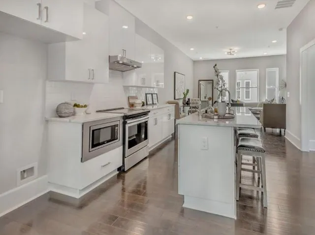 a kitchen with a stove a sink and a microwave