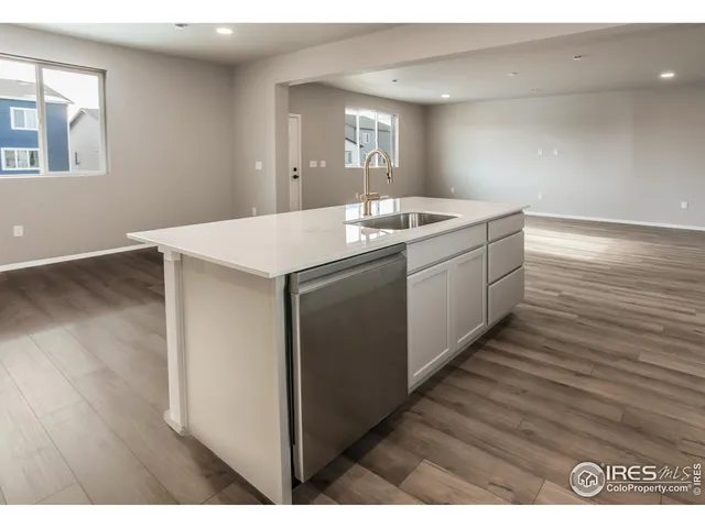 a kitchen with a sink cabinets and wooden floor