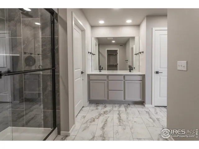 a bathroom with a shower and a sink