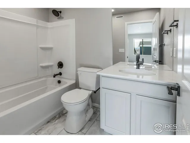 a bathroom with a toilet and a bathtub
