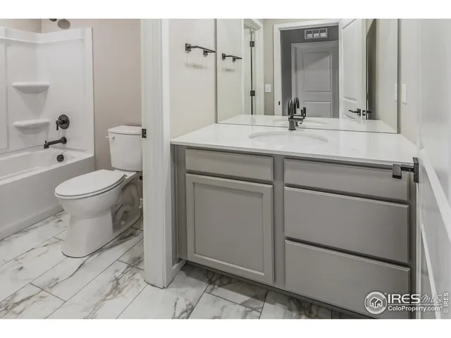a bathroom with a bathtub and a toilet