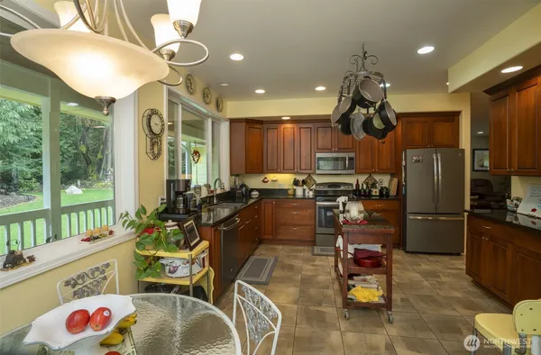 a kitchen with a large window and cabinets