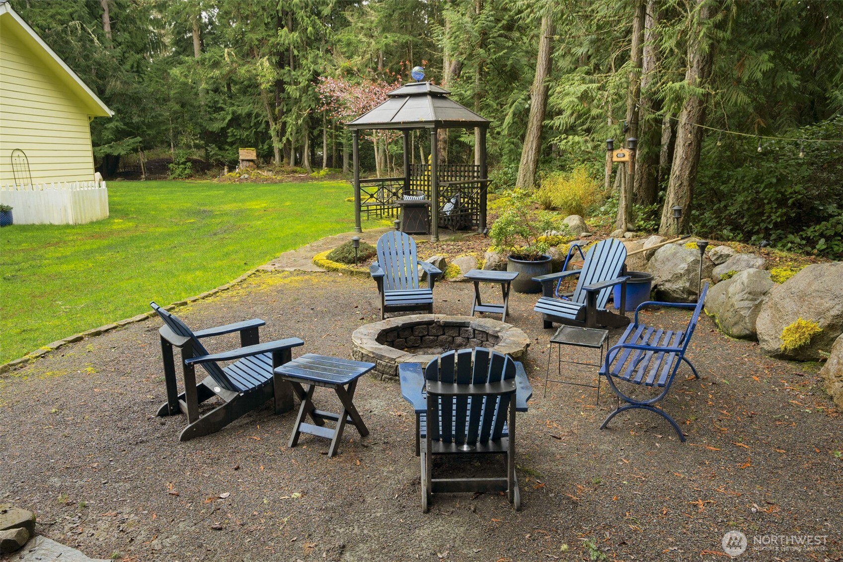 72 Doe Place Sequim, WA 98382 - Photo 31 of 40 a view of a patio with a table chairs and a table