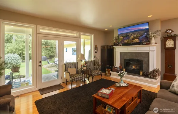a living room with furniture a fireplace and a floor to ceiling window