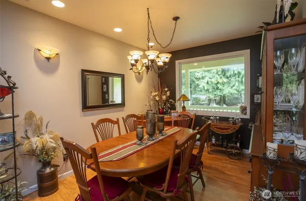 a view of a dining room with furniture wooden floor and chandelier