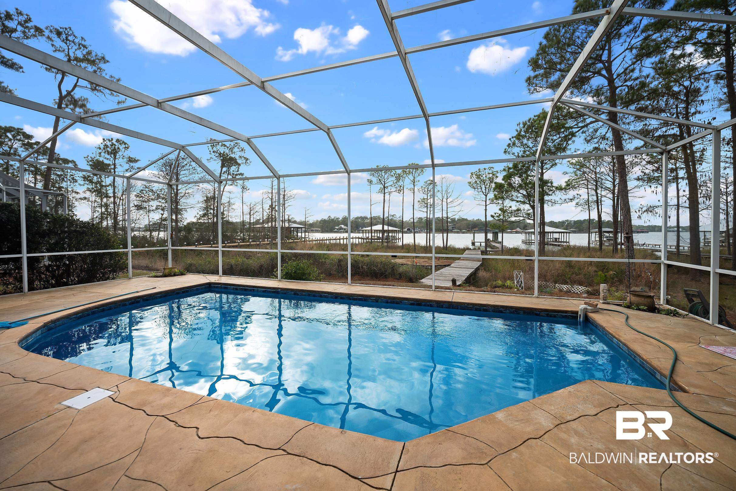8591 Bay Harbor Road Elberta, AL 36530 - Photo 12 of 56 Swimming pool featuring a sunroom, a lanai, a water view, and a patio area