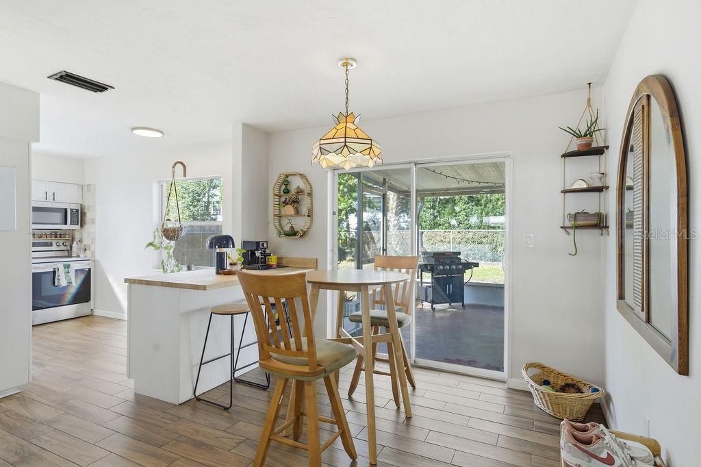 8520 109th Way North Seminole, FL 33772 - Photo 11 of 40 a dining room with furniture window wooden floor