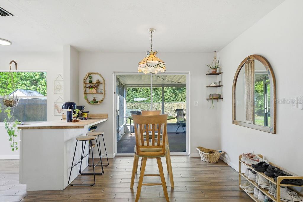 8520 109th Way North Seminole, FL 33772 - Photo 15 of 40 a view of a dining room with furniture window and wooden floor