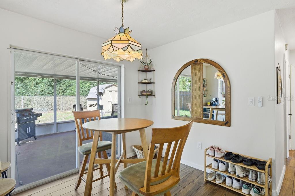 8520 109th Way North Seminole, FL 33772 - Photo 16 of 40 a view of a dining room with furniture a chandelier and wooden floor