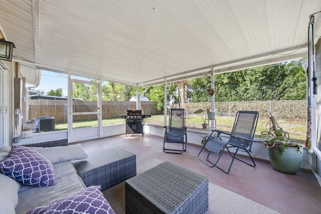 8520 109th Way North Seminole, FL 33772 - Photo 17 of 40 a living room with furniture and a floor to ceiling window