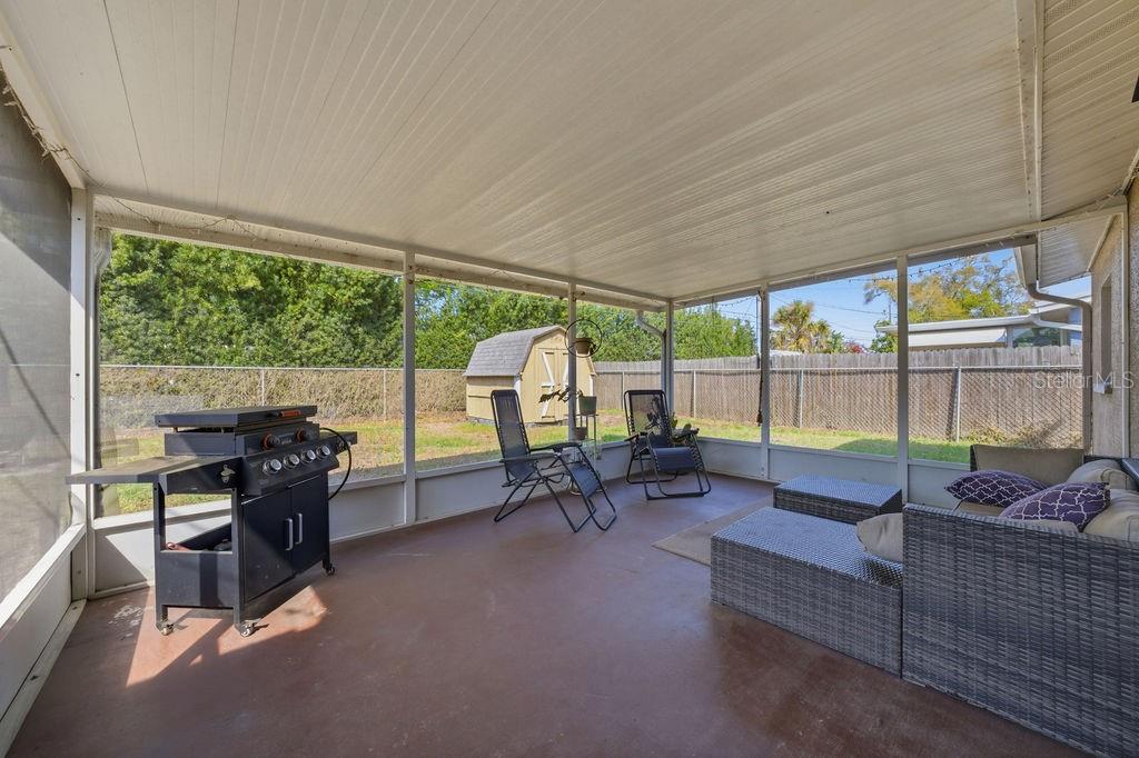 8520 109th Way North Seminole, FL 33772 - Photo 19 of 40 a living room with furniture and a floor to ceiling window
