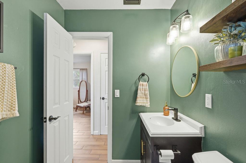 8520 109th Way North Seminole, FL 33772 - Photo 22 of 40 a bathroom with a sink mirror and vanity