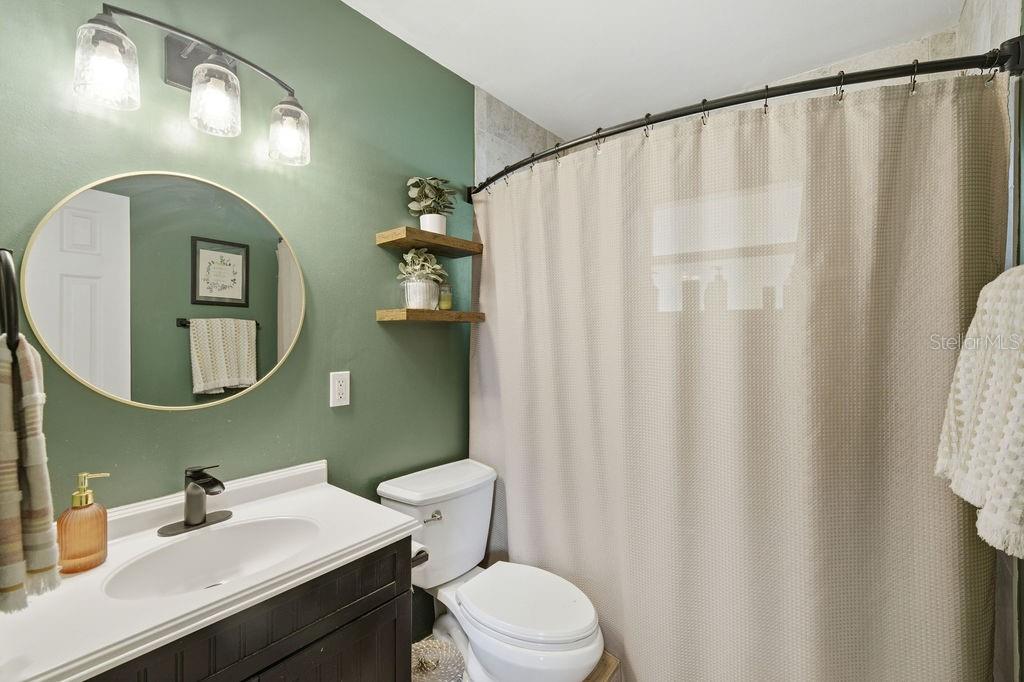 8520 109th Way North Seminole, FL 33772 - Photo 23 of 40 a bathroom with a sink mirror and toilet
