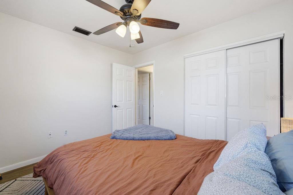 8520 109th Way North Seminole, FL 33772 - Photo 26 of 40 a bedroom with a bed and a chandelier