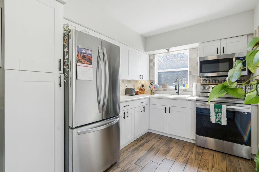 8520 109th Way North Seminole, FL 33772 - Photo 7 of 40 a kitchen with stainless steel appliances a refrigerator sink and microwave