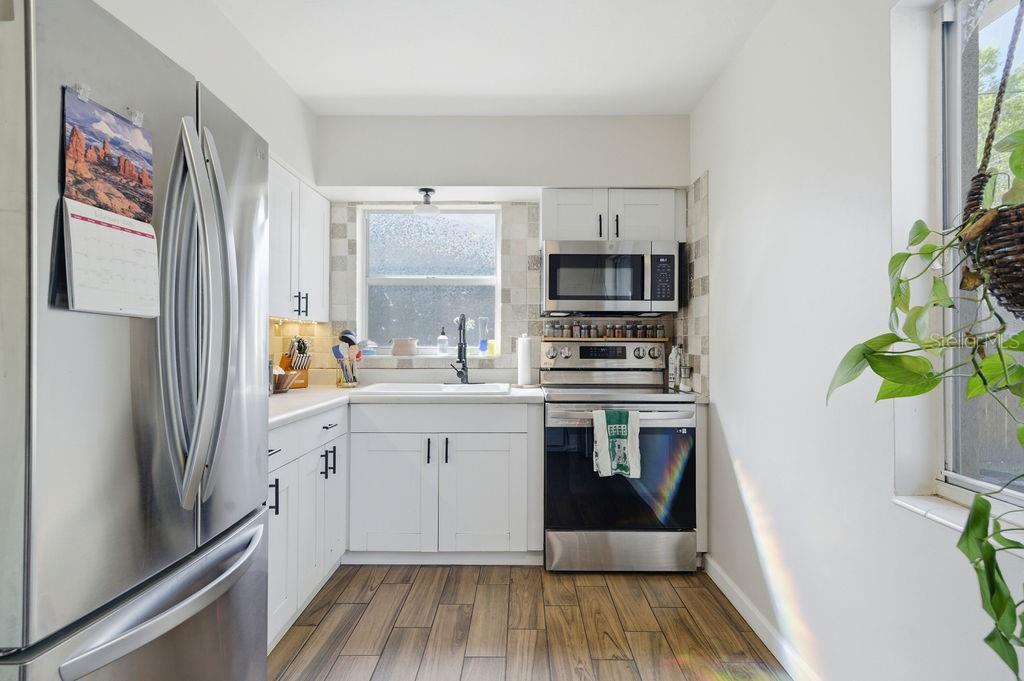 8520 109th Way North Seminole, FL 33772 - Photo 9 of 40 a kitchen with stainless steel appliances a stove a sink and a refrigerator