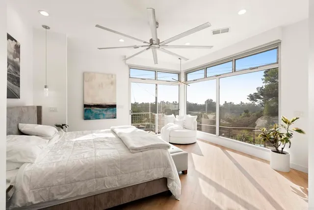 a bedroom with a bed and a large window