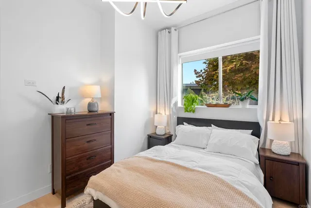 a bedroom with a bed and a window