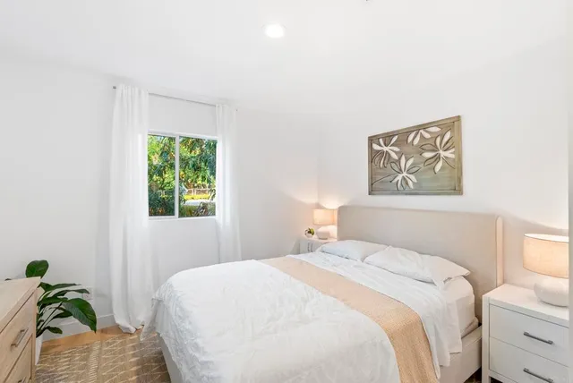 a bedroom with a bed and a painting on the wall