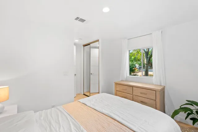 a bedroom with a bed and a window