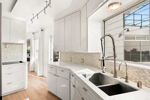 a kitchen with a sink cabinets and window