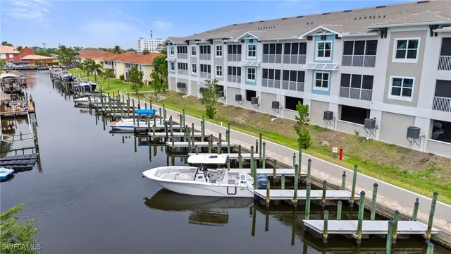 a large swimming pool with outdoor seating and plants
