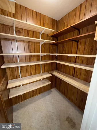 a view of an empty room with empty shelves