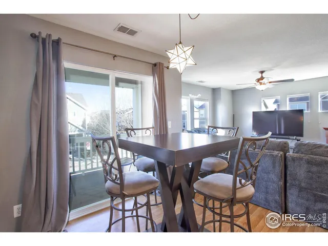a view of a dining room with furniture wooden floor and chandelier