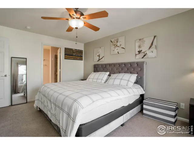 a bedroom with a bed and a ceiling fan