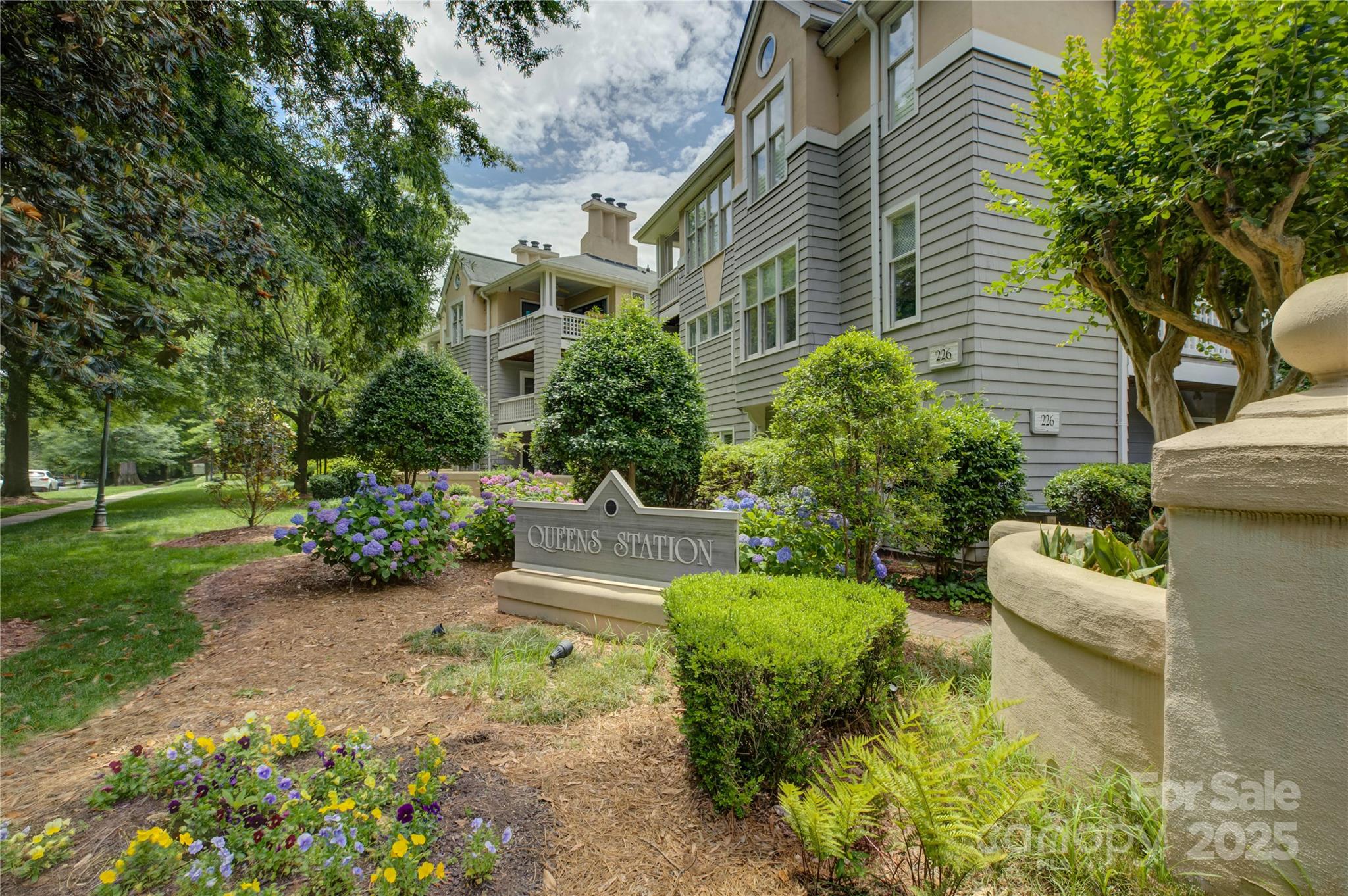 226 Queens Road, Unit 68 Charlotte, NC 28204 - Photo 1 of 40 a view of a garden with couches and potted plants