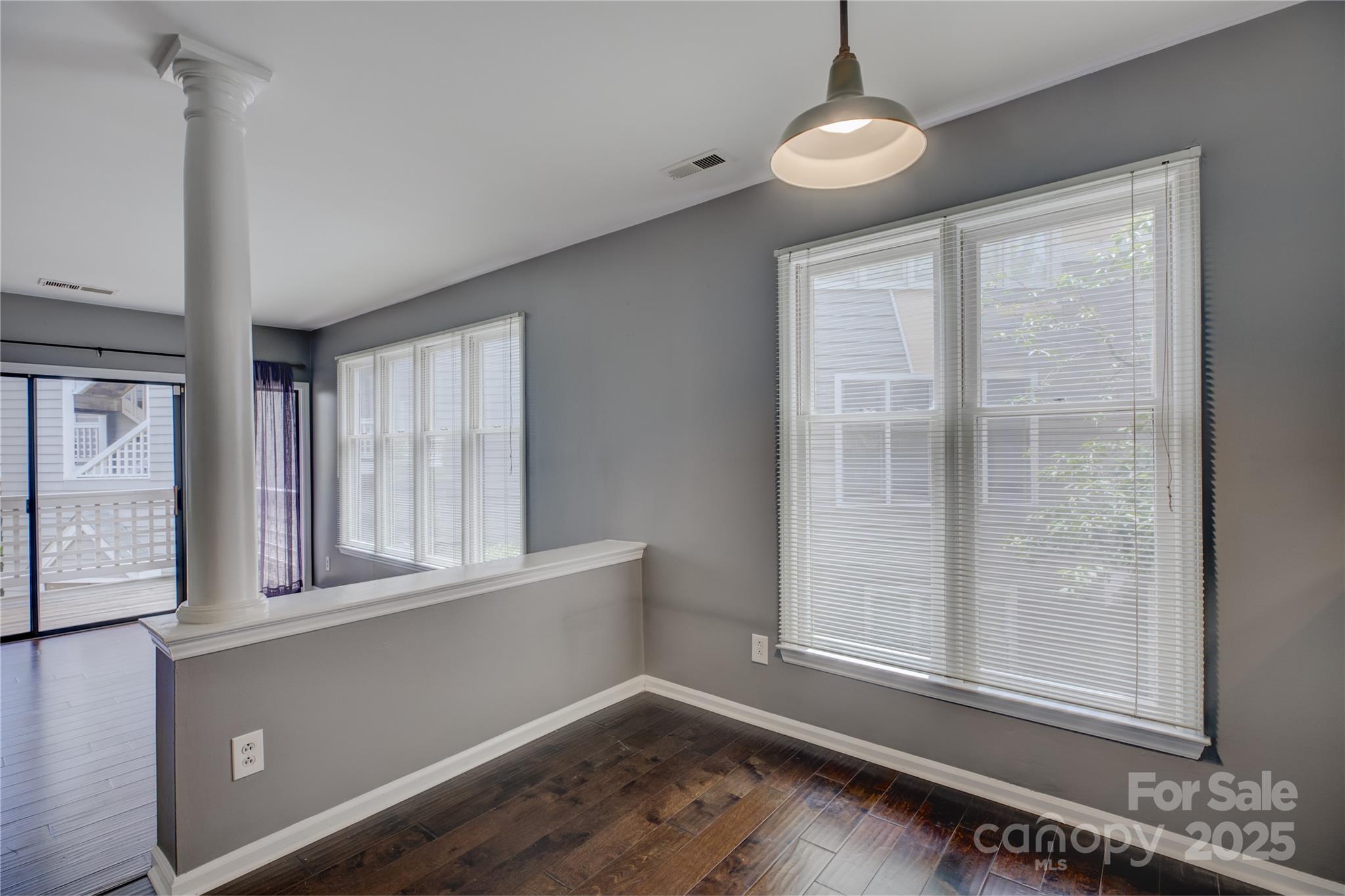 226 Queens Road, Unit 68 Charlotte, NC 28204 - Photo 11 of 40 an empty room with wooden floor and windows