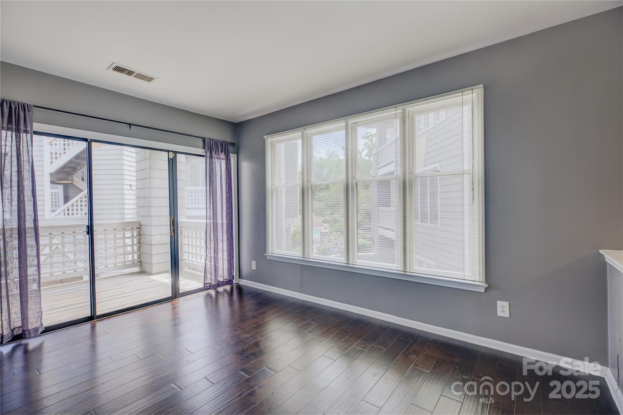 226 Queens Road, Unit 68 Charlotte, NC 28204 - Photo 12 of 40 a view of an empty room with wooden floor and a window