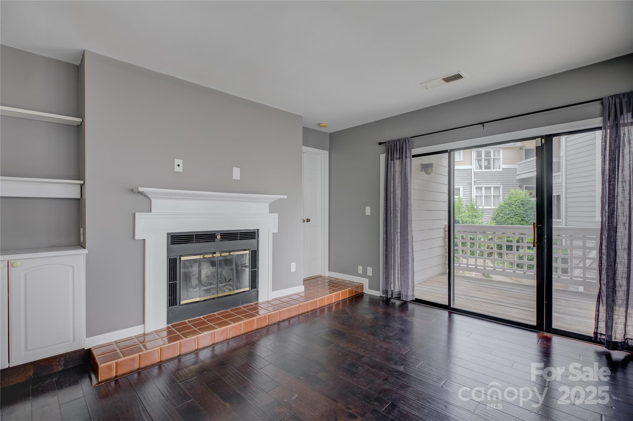 226 Queens Road, Unit 68 Charlotte, NC 28204 - Photo 13 of 40 a living room with wooden floor and a fireplace