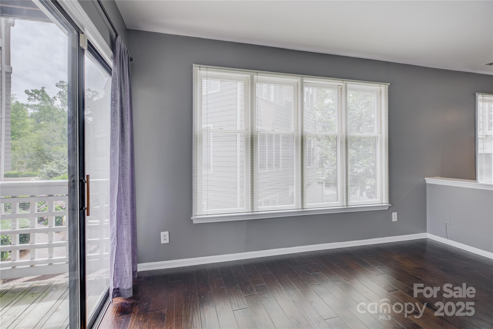 226 Queens Road, Unit 68 Charlotte, NC 28204 - Photo 14 of 40 an empty room with wooden floor and windows