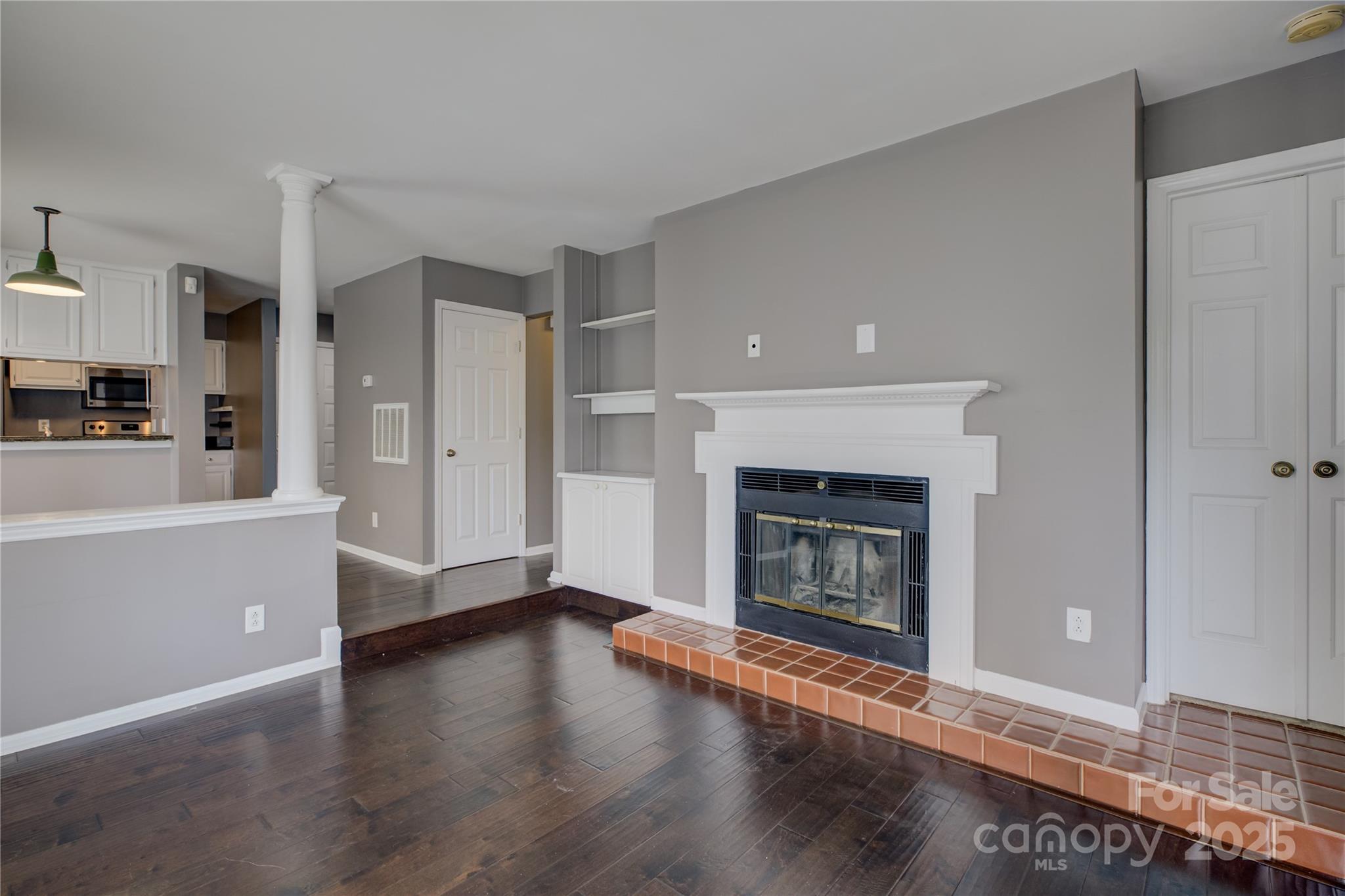226 Queens Road, Unit 68 Charlotte, NC 28204 - Photo 15 of 40 a view of a livingroom with wooden floor and a fireplace