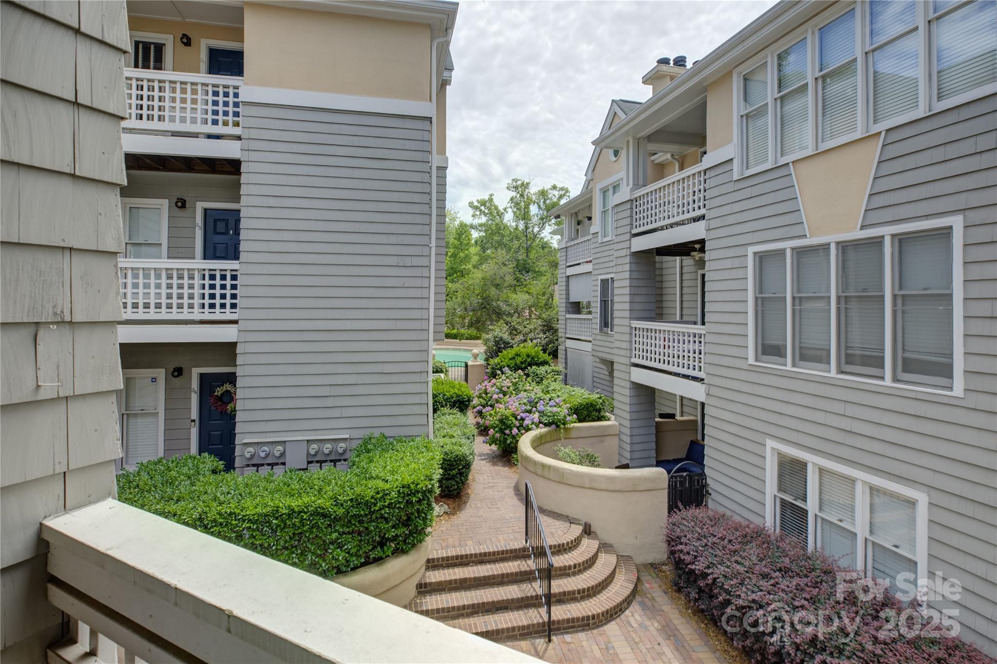 226 Queens Road, Unit 68 Charlotte, NC 28204 - Photo 20 of 40 a view of a patio with couches chairs and potted plants