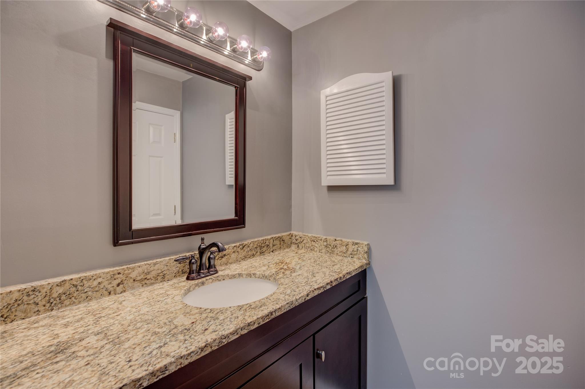 226 Queens Road, Unit 68 Charlotte, NC 28204 - Photo 25 of 40 a bathroom with a granite countertop sink and a mirror
