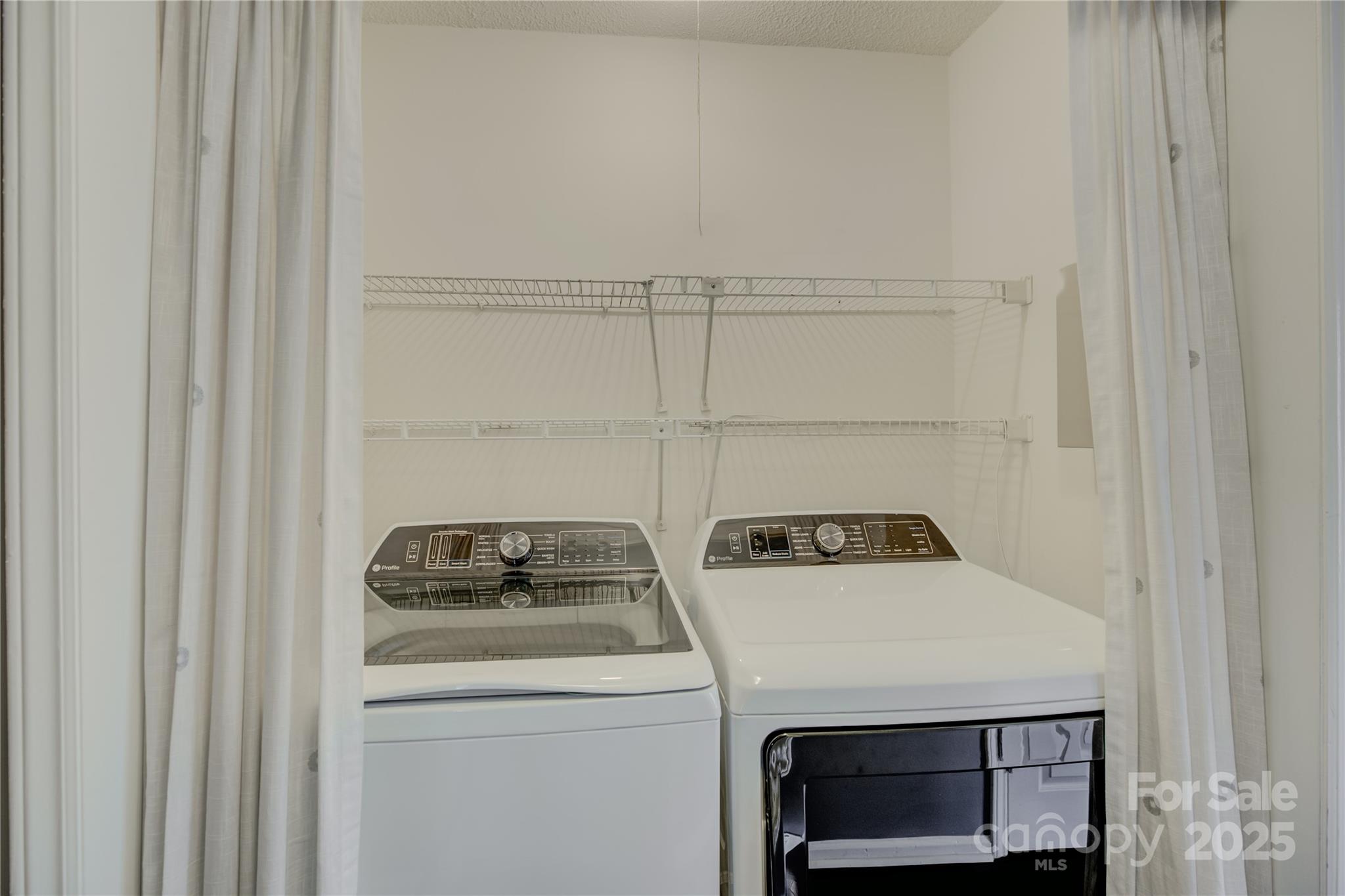 226 Queens Road, Unit 68 Charlotte, NC 28204 - Photo 31 of 40 a utility room with dryer and washer