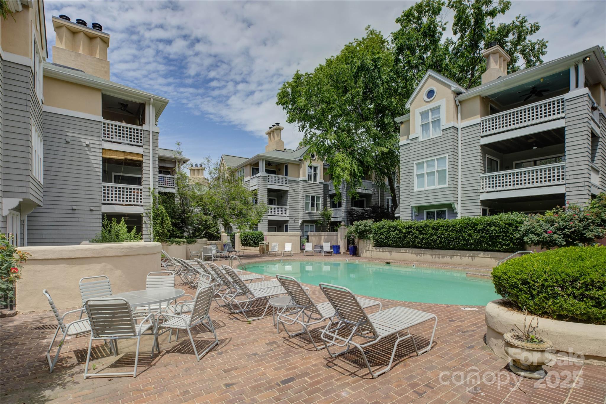226 Queens Road, Unit 68 Charlotte, NC 28204 - Photo 40 of 40 a view of a patio with table and chairs and potted plants