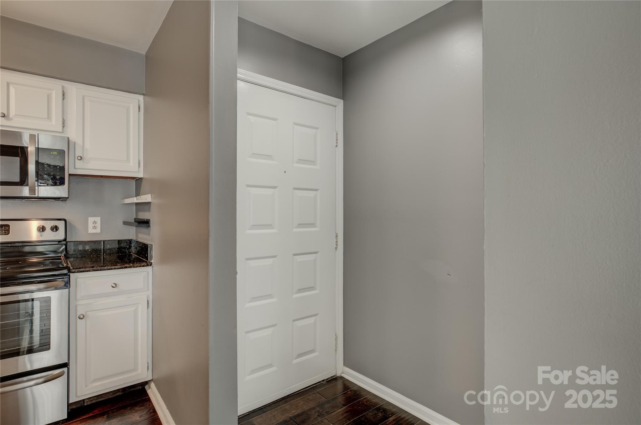 226 Queens Road, Unit 68 Charlotte, NC 28204 - Photo 5 of 40 a kitchen with granite countertop white cabinets and white appliances