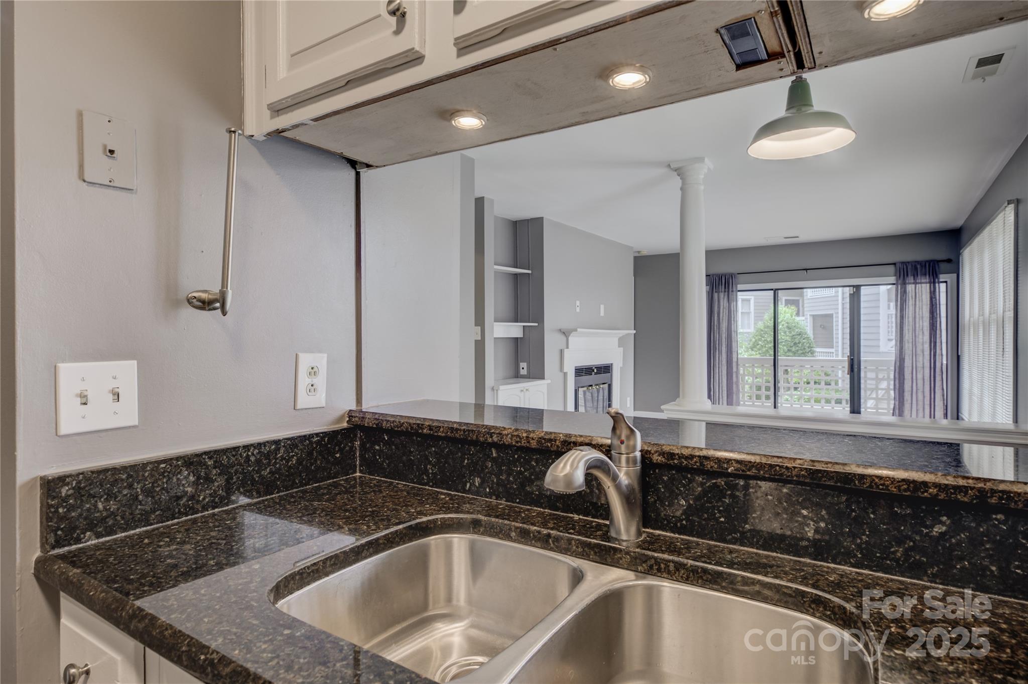 226 Queens Road, Unit 68 Charlotte, NC 28204 - Photo 7 of 40 a kitchen with a sink a counter space and cabinets